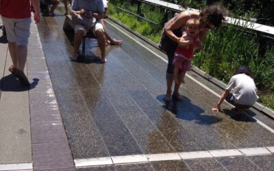 No calor, os visitantes curtem os pisos com água no High Line Parque em Nova Iorque